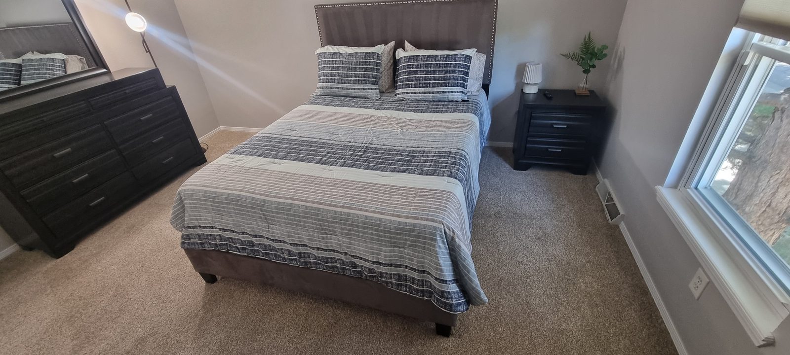 Bedroom staged and linens reset during an Airbnb turnover cleaning in Denver